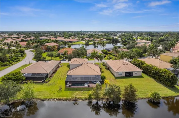 Birds eye view of property with a water view