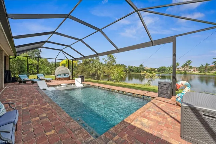 View of swimming pool with a water view, ac unit, a lanai, and a patio