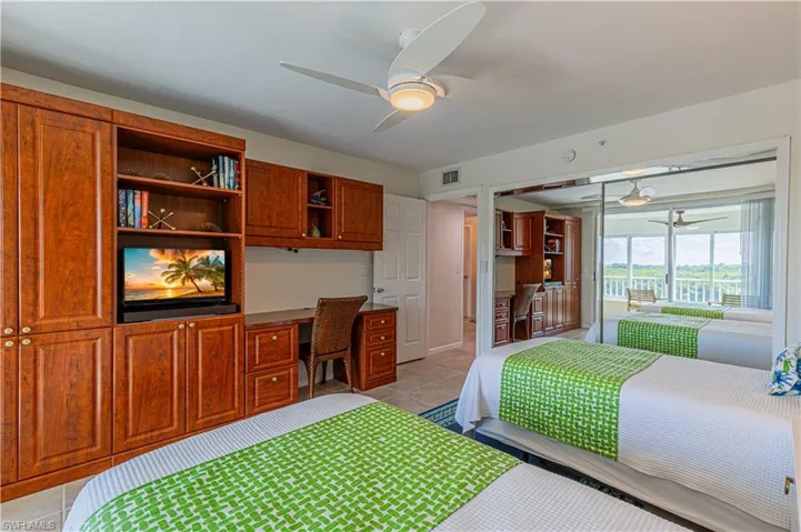 Second bedroom with a closet, ceiling fan, and built in desk