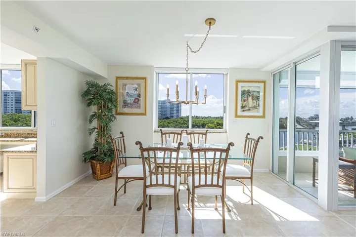 Tiled dining area featuring a chandelier