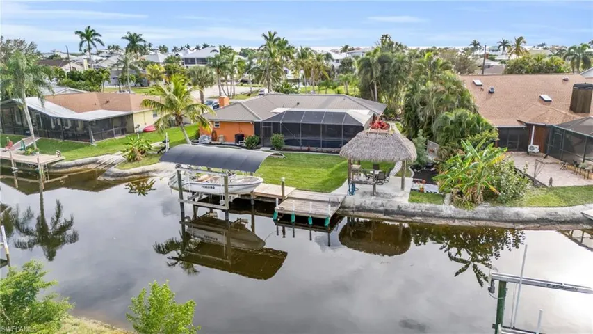 Covered 10,000 lb Covered Boat Lift, Dock, & Large Tiki Hut