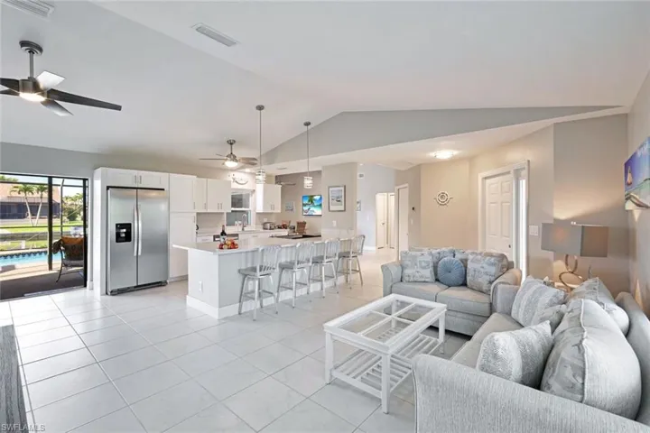 The bright & open plan Living area with views over the Kitchen & Pool Deck