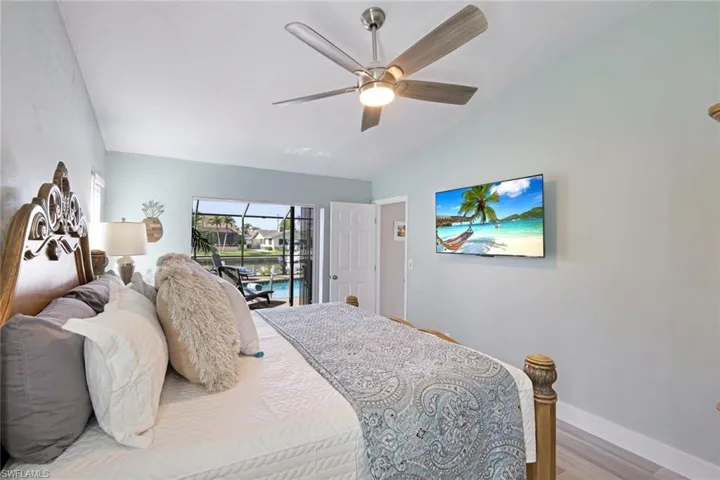 The Master Bedroom has tile floor + sliders to the Pool Deck