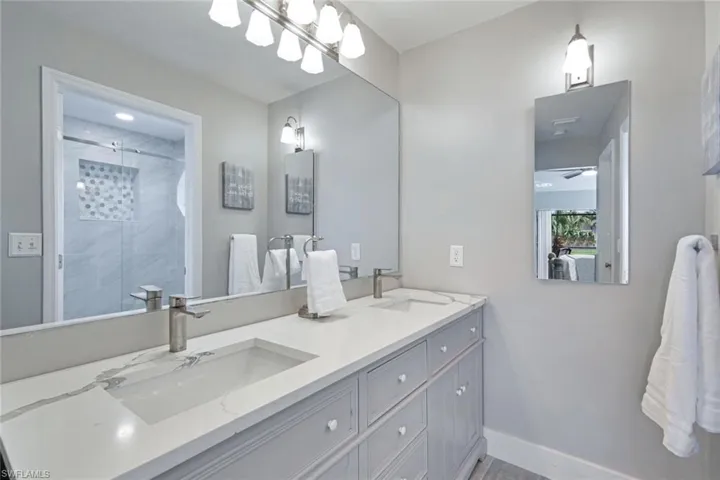 The ensuite Master Bath with twin basins + walk in shower