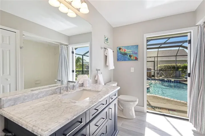 The Guest Bathroom has a Bathtub/Shower combo + pool door to the pool deck for added convenience