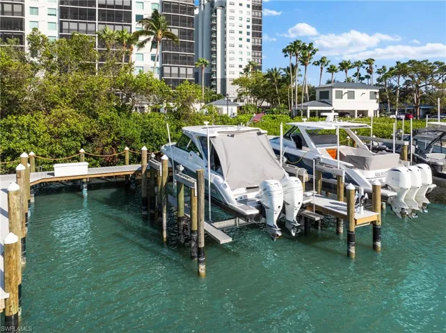 Dock area with a water view and boat lift