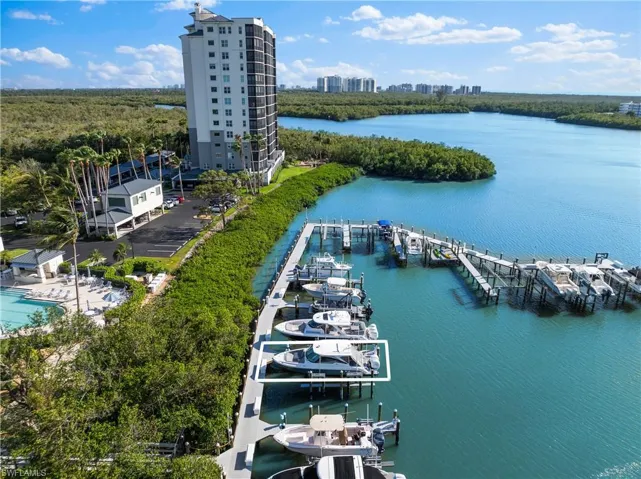 Birds eye view of property with a water view