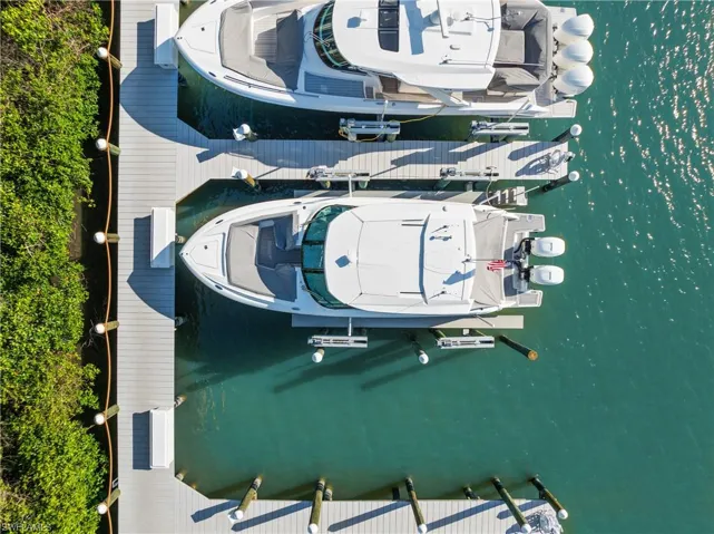 Birds eye view of property with a water view