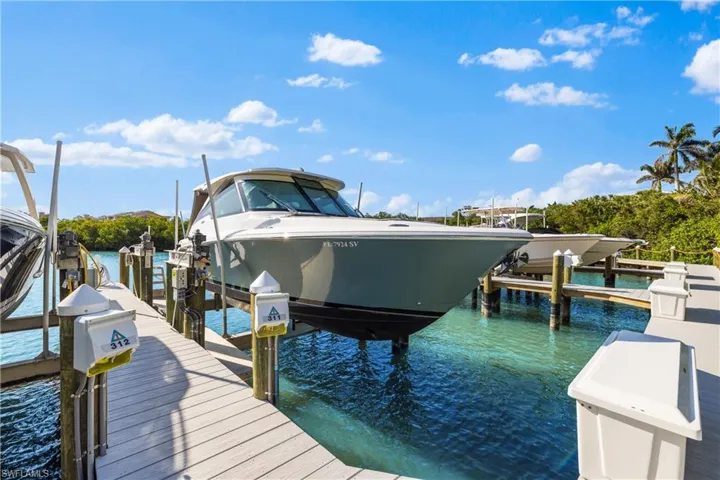 View of dock with a water view and boat lift
