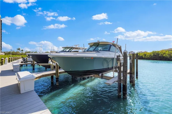 Dock area featuring a water view and boat lift