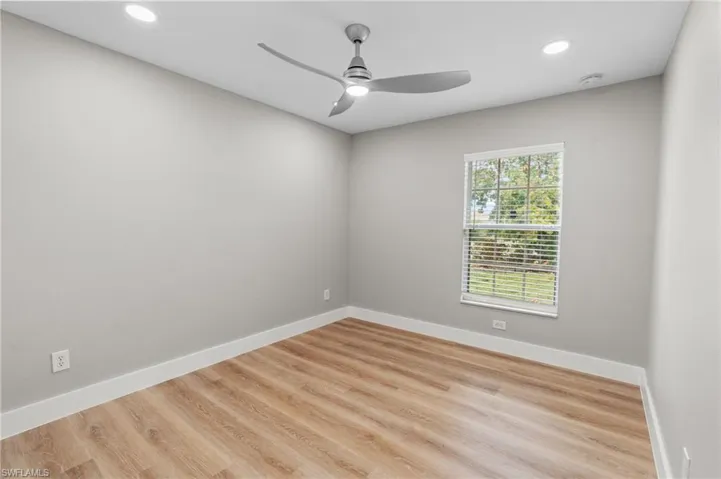 Spare room featuring wood finished floors, recessed lighting, and a ceiling fan