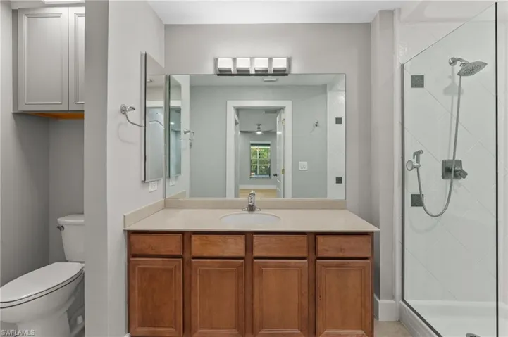 Full bathroom featuring a stall shower and vanity