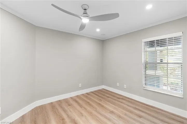 Unfurnished room with ornamental molding, light wood finished floors, a ceiling fan, and recessed lighting