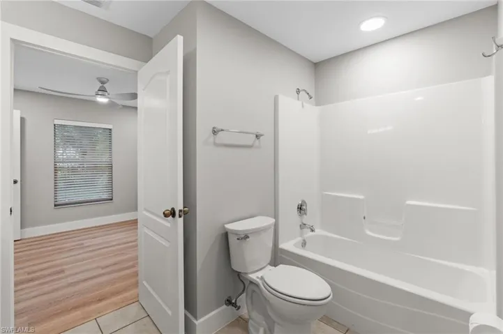 Full bathroom with shower / bathtub combination and light tile patterned floors
