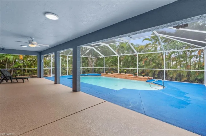 Outdoor pool featuring a lanai, a sunroom, and a patio