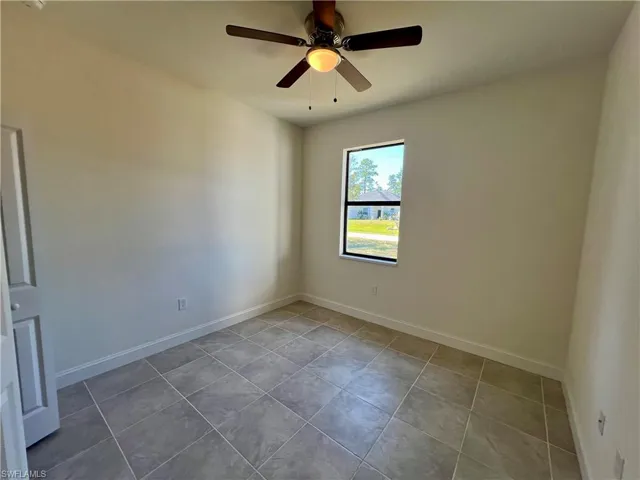 Guest bedroom featuring ceiling fan