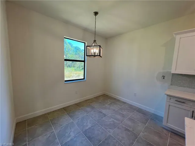 Dining room off of the kitchen with tile floors.