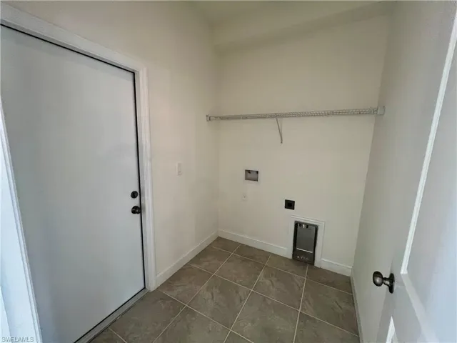 Clothes washing area with washer hookup, hookup for an electric dryer.