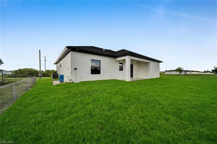 Rear view of house featuring stucco siding