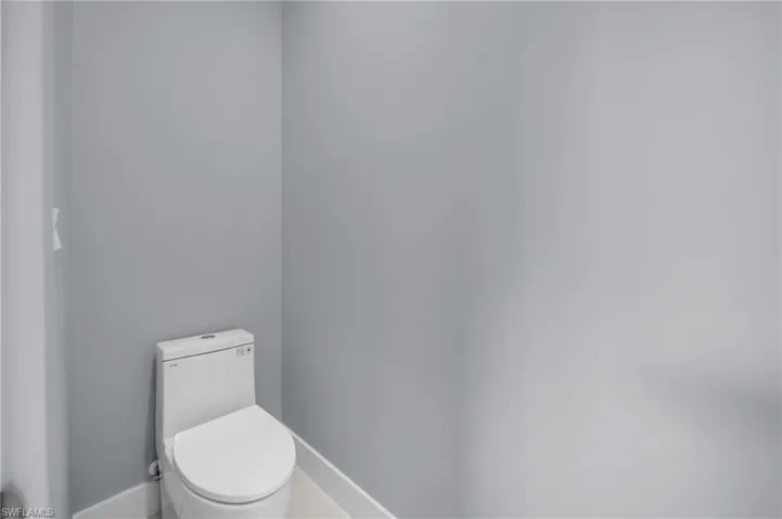 Bathroom with baseboards and toilet