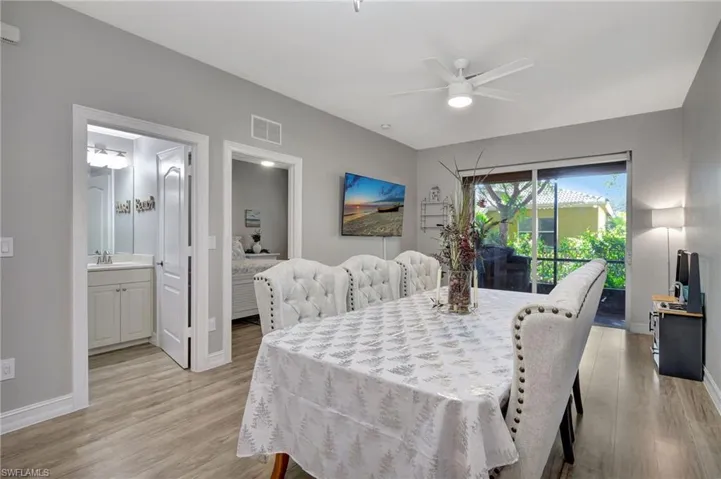Dining area with ceiling fan, light wood-type flooring, and sink