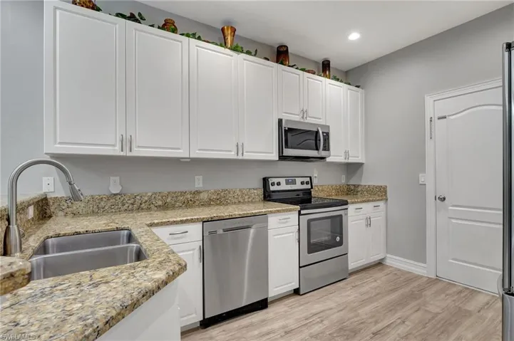Kitchen with white cabinets, stainless steel appliances