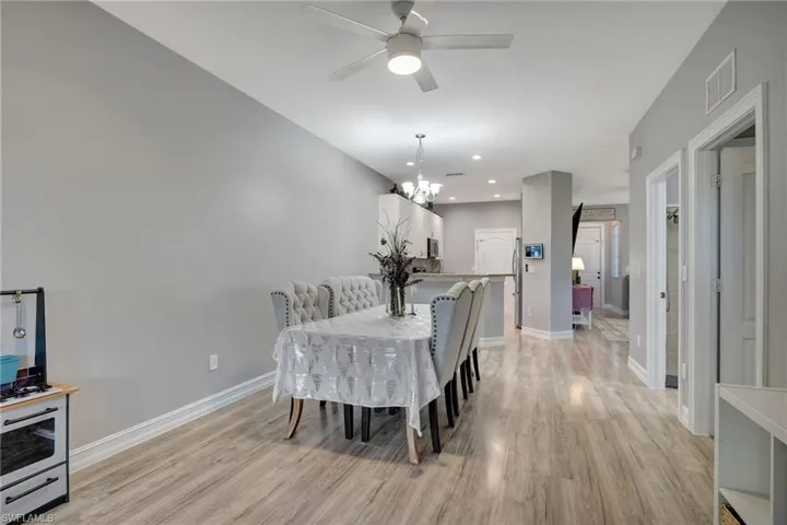 Dining room featuring ceiling fan with notable chandelier