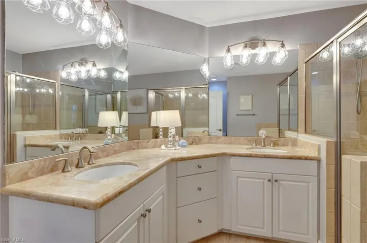 Master Bathroom with double vanity and a shower with door