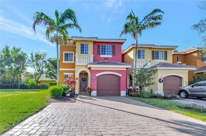 Mediterranean / spanish-style home featuring a front lawn and a garage