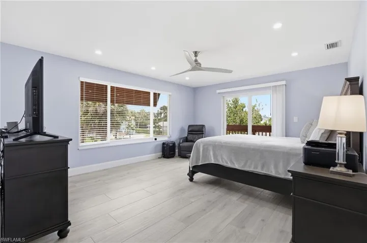 Bright interior featuring light wood-finish flooring, recessed lighting, and a modern ceiling fan