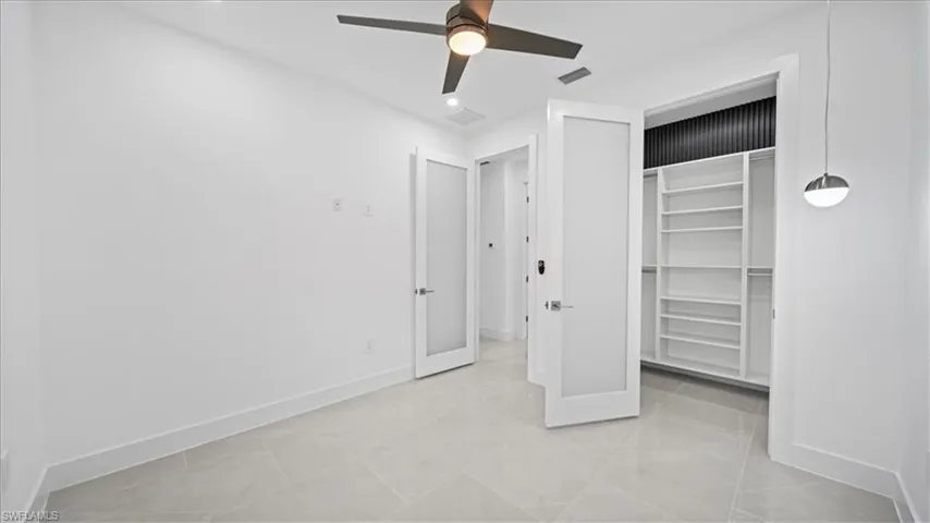 Unfurnished bedroom with a closet, a ceiling fan, and recessed lighting
