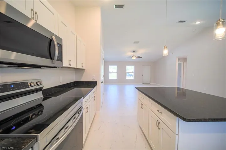The Island Kitchen Comes With Black Granite Countertops And Backsplash, White Shaker Wooden Soft Close Cabinets And Drawers, Stainless Steel Appliances, Pendant Lighting, Stainless Steel Fixtures, And A Large Walk-In Pantry!