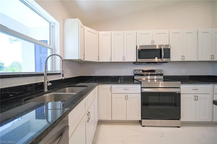 The Island Kitchen Comes With Black Granite Countertops And Backsplash, White Shaker Wooden Soft Close Cabinets And Drawers, Stainless Steel Appliances, Pendant Lighting, Stainless Steel Fixtures, And A Large Walk-In Pantry!