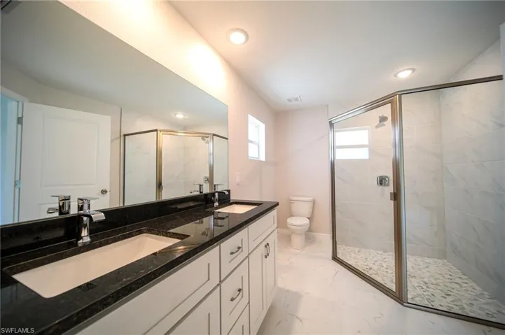 The Master Bathroom Has A Glassed In Walk-In Shower, Granite Countertops, Dual Sinks, And Stainless Steel Fixtures!