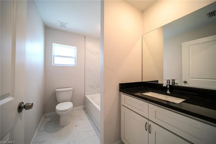 The Spare Bathroom Has A Tiled Tub Area, Granite Countertops, And Stainless Steel Fixtures!
