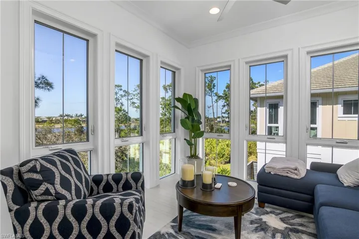 View of sunroom, note the rich wood trim around the windows, that start at floor level and run nearly to the ceiling.  Casement windows open to let in the tropical fresh air.