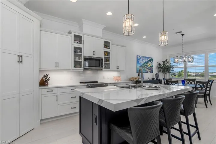 Terrific gathering space, 3 bar stools, dining space in the foreground.