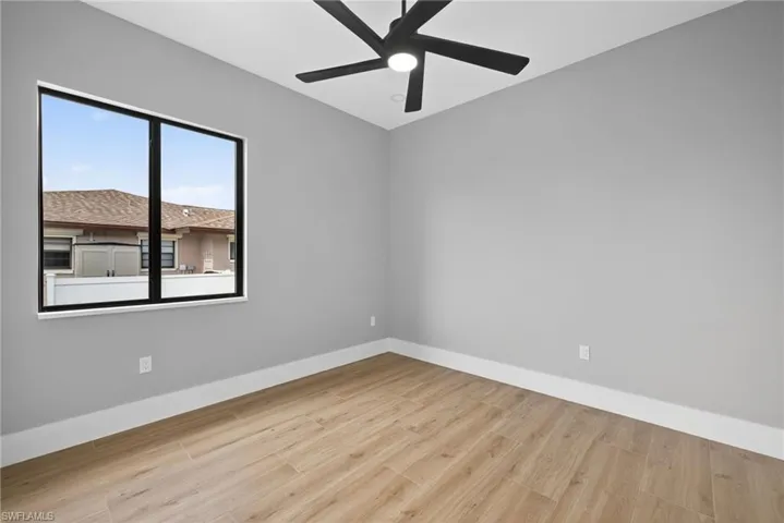 Spare room featuring light wood-type flooring and ceiling fan