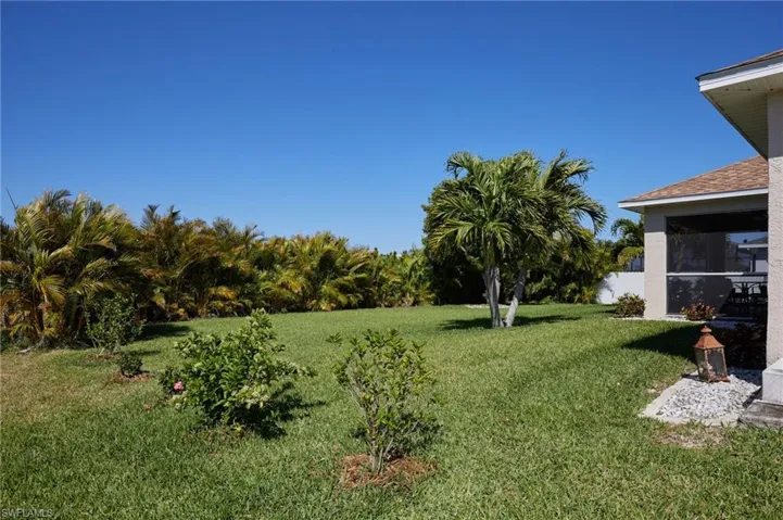 View of green lawn with a sunroom