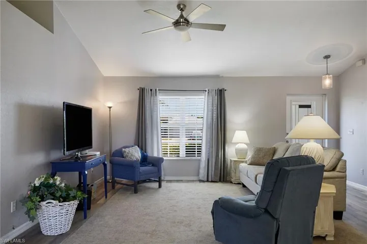 Living area featuring baseboards and a ceiling fan