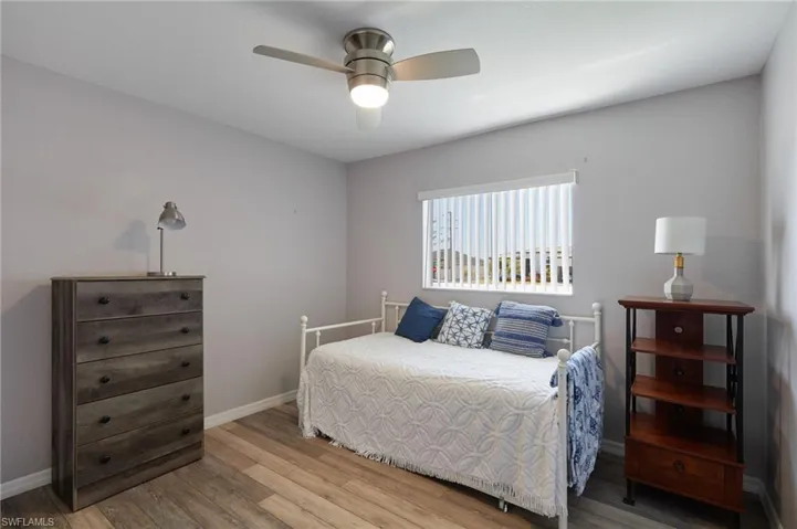 Bedroom with wood finished floors and ceiling fan