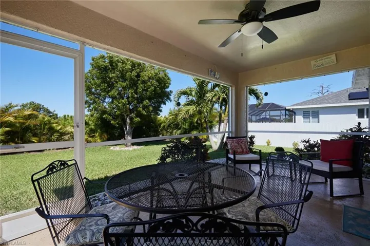 Sunroom with outdoor dining area, ceiling fan, a patio area, and healthy amount of natural light