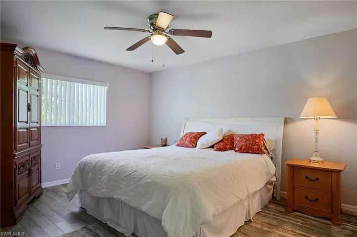 Bedroom with ceiling fan and hardwood / wood-style floors