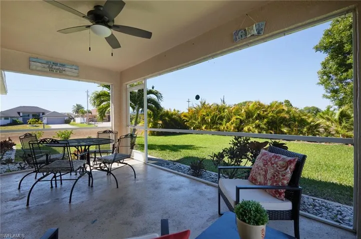 View of patio with ceiling fan and outdoor dining area