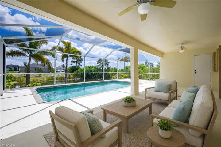 Screened lanai featuring a swimming pool and water views