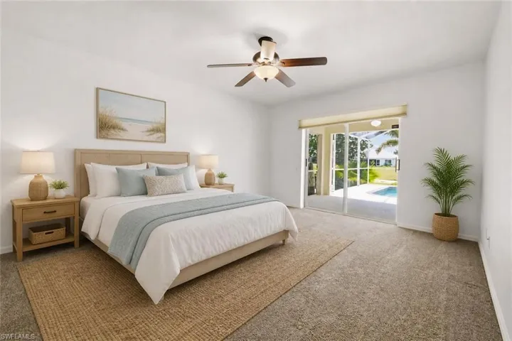 Bedroom featuring light-colored carpeting and a ceiling fan with integrated lighting