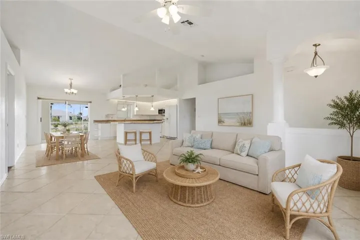 Expansive open-concept living area featuring a vaulted ceiling and tile flooring throughout