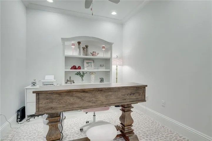 Bathroom with vanity, ceiling fan, and crown molding