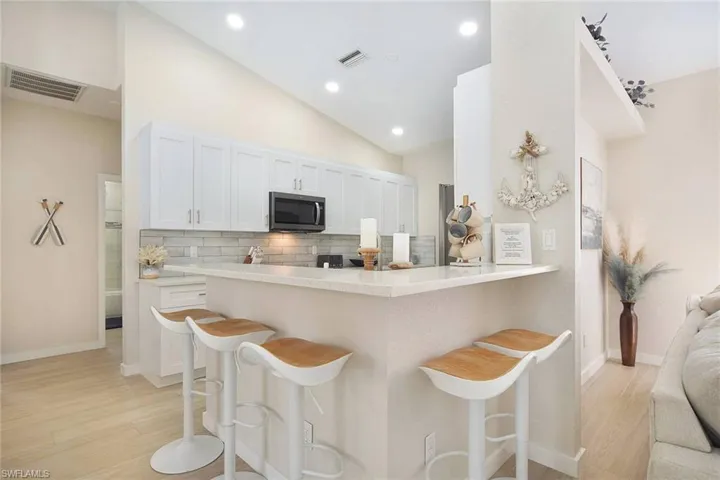 raised quartz countertops allows plenty of space for countertop buffets or serving drinks to friends