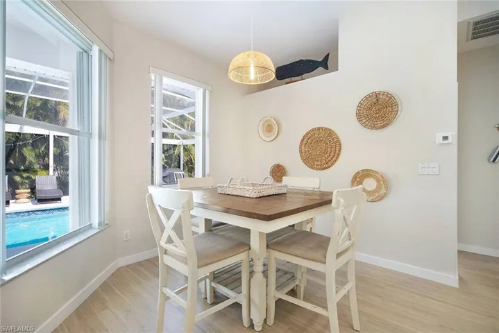 bar height table and chairs perfect for looking out to pool and landscaped area